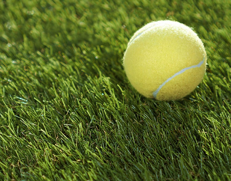 Artificial,grass,background.,tennis,ball,lying,on,the,green,soft